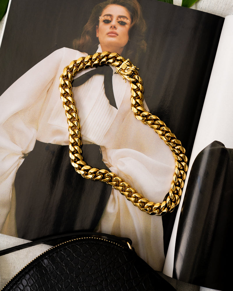 14MM Wide Curb Chain Chunky Gold 18" inch long Cuban Link Necklace  on a fashion magazine next to a black purse